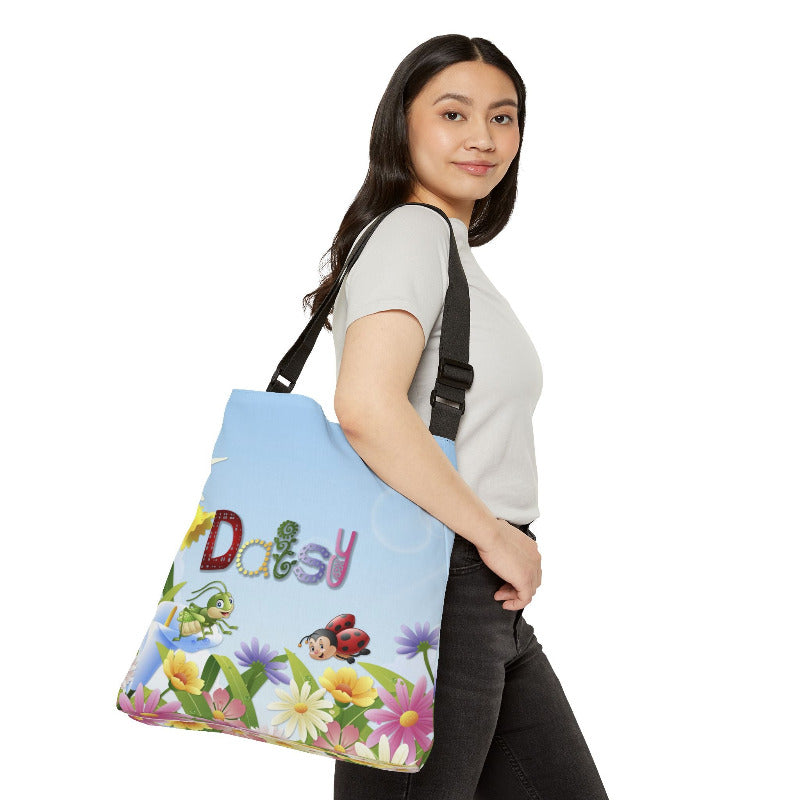Woman holding a colorful tote bag with acrostic poem spelling out 'Daisy' and cartoon characters on a white background