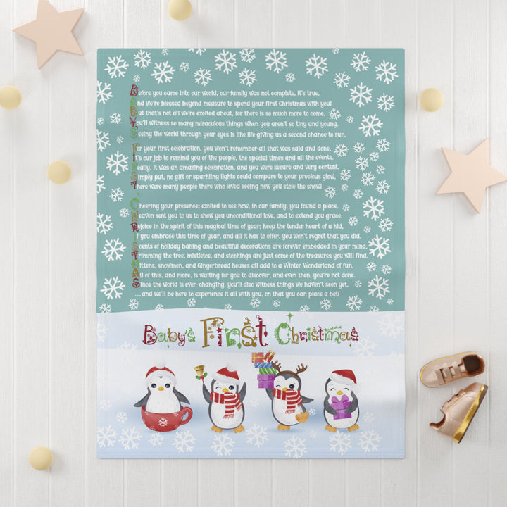 Baby's First Christmas acrostic poem blanket with festive penguins and snowflake border on teal background with white wooden surface