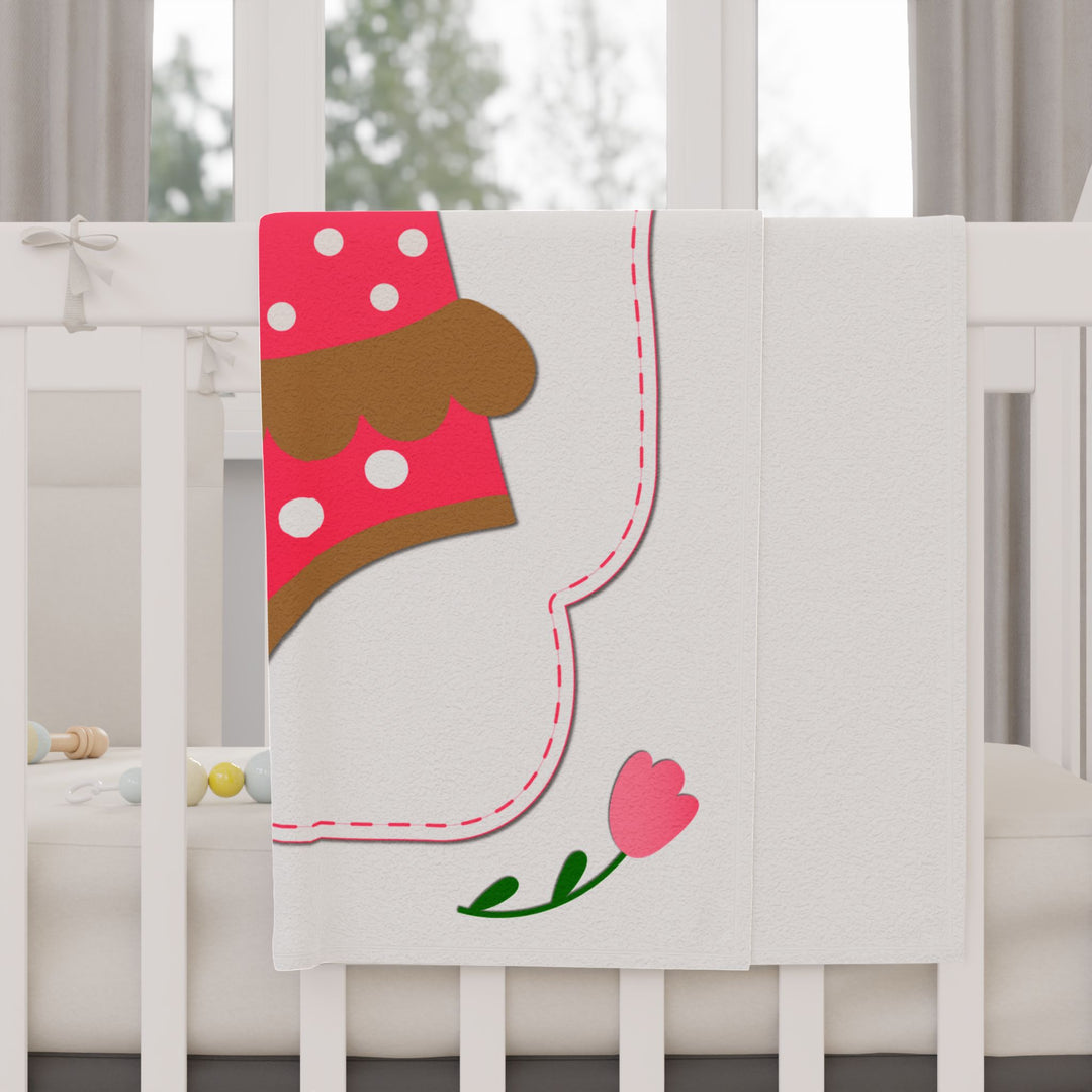 It's a Girl acrostic poem folded pink blanket with polka dot baby bodysuit design on white crib
