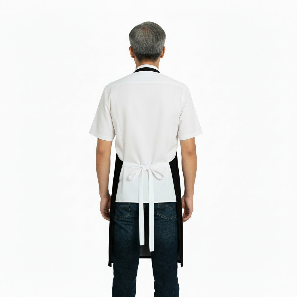 Person wearing a white shirt, black apron, and jeans on a white background