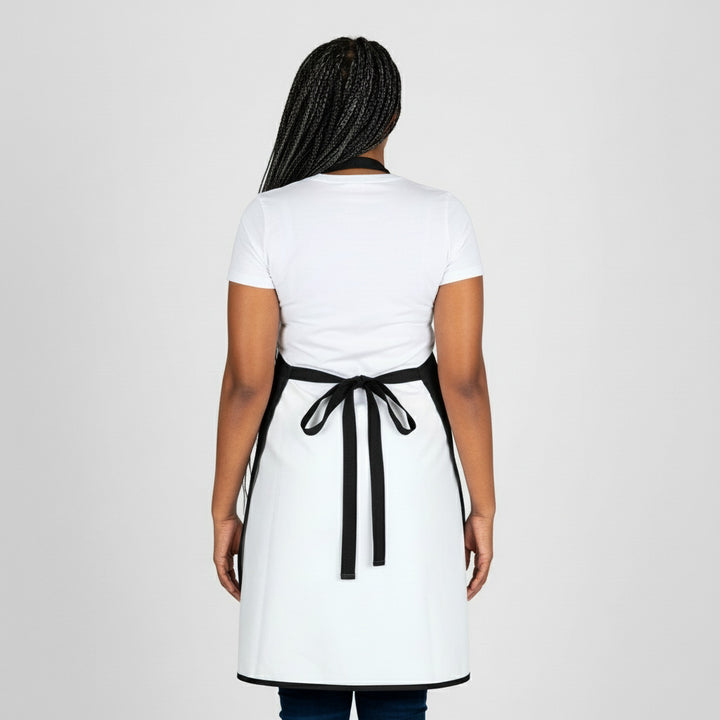 Person wearing a white apron with a black belt on a white background