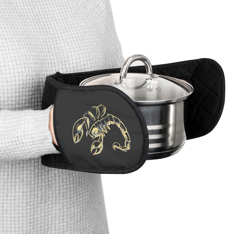 Person holding a pot with a lid using a black oven mitt with acrostic poem spelling out Scorpio design.