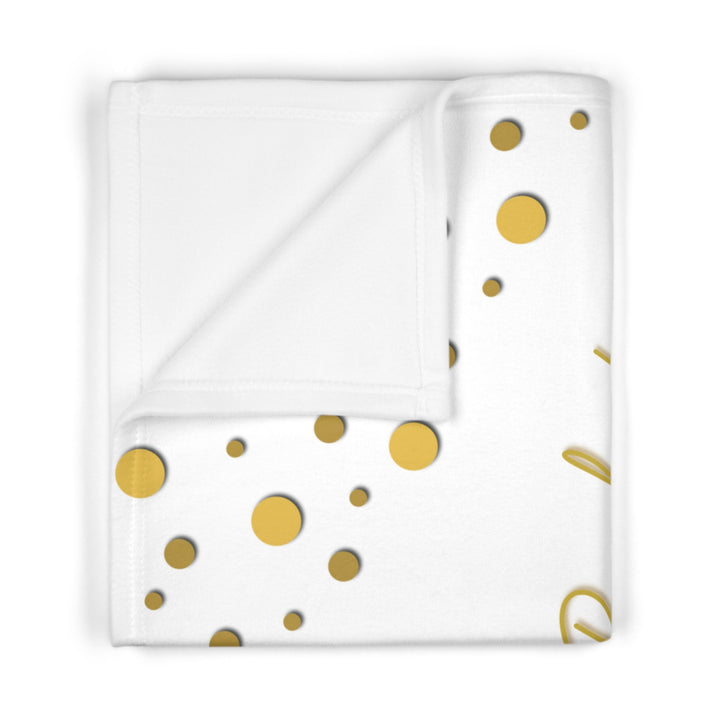 Oh, Baby acrostic poem folded blanket with gold text and confetti dots on white background
