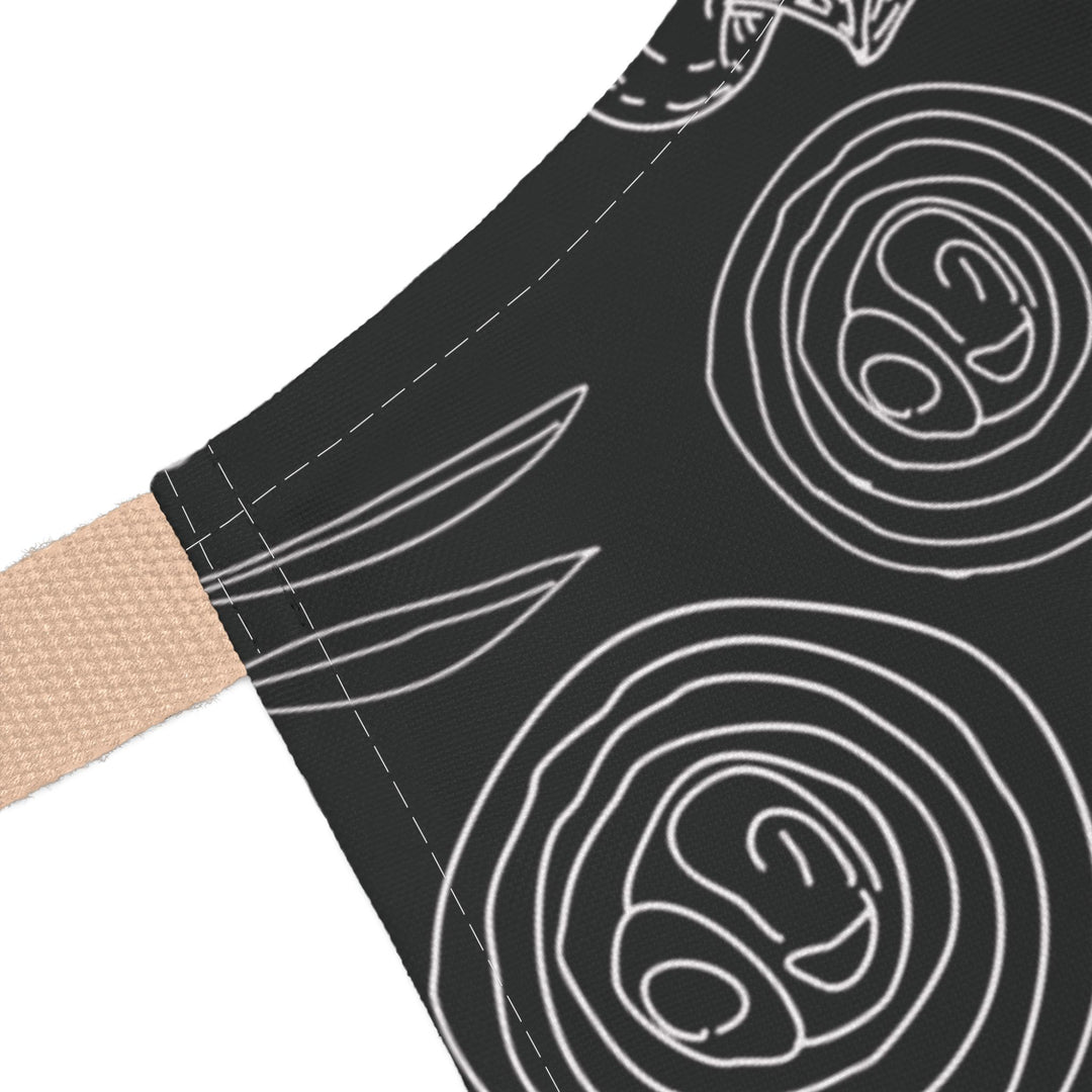 Black fabric with white line art patterns and a beige strap on a white background
