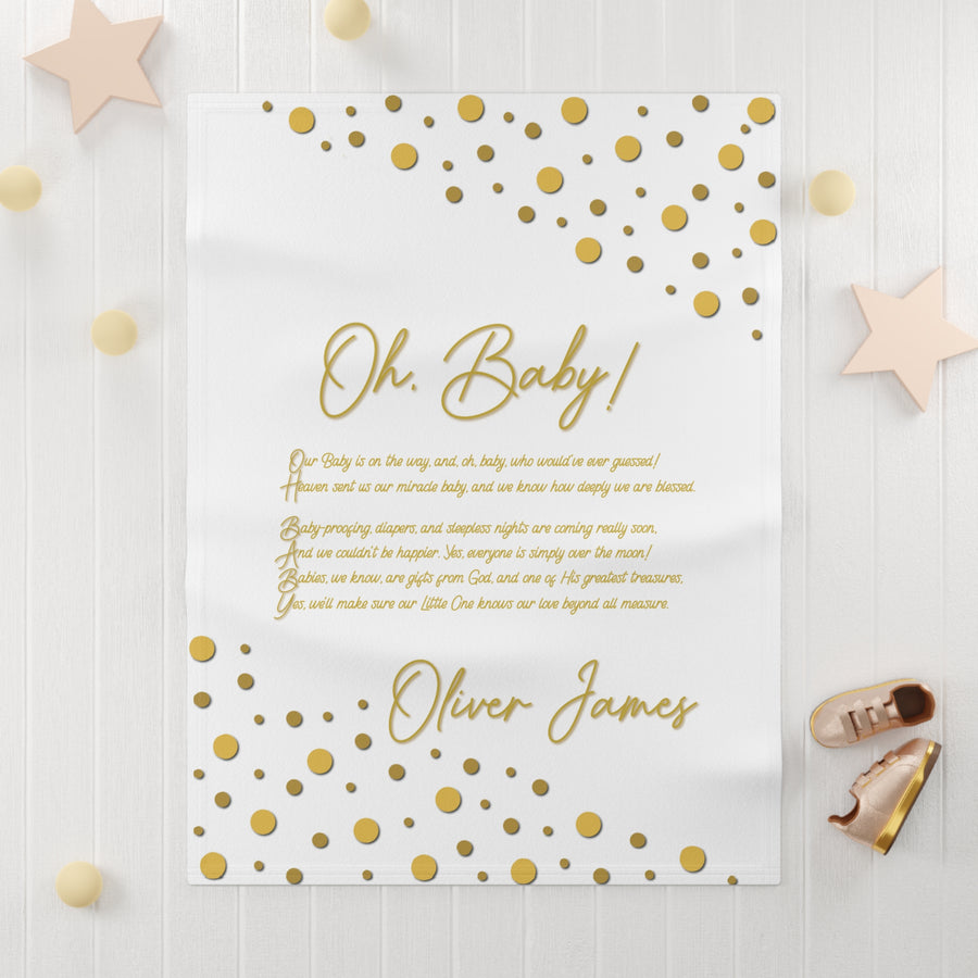Oh, Baby acrostic poem blanket with gold text and confetti dots on white background with light wooden surface