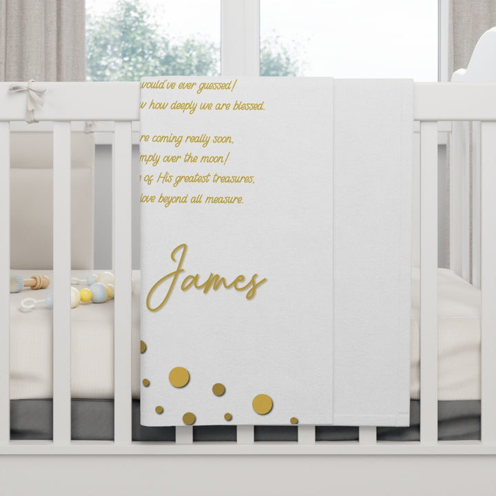 Oh, Baby acrostic poem blanket with gold text and confetti dots on white crib
