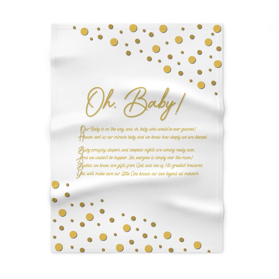 Baby shower blanket with gold polka dots and text on a white background
