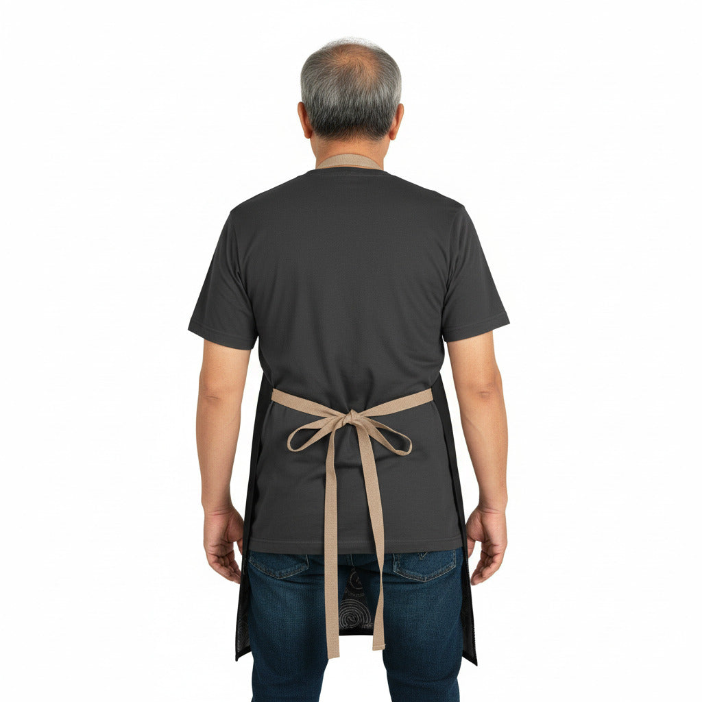 Person wearing a black apron with a beige strap on a white background