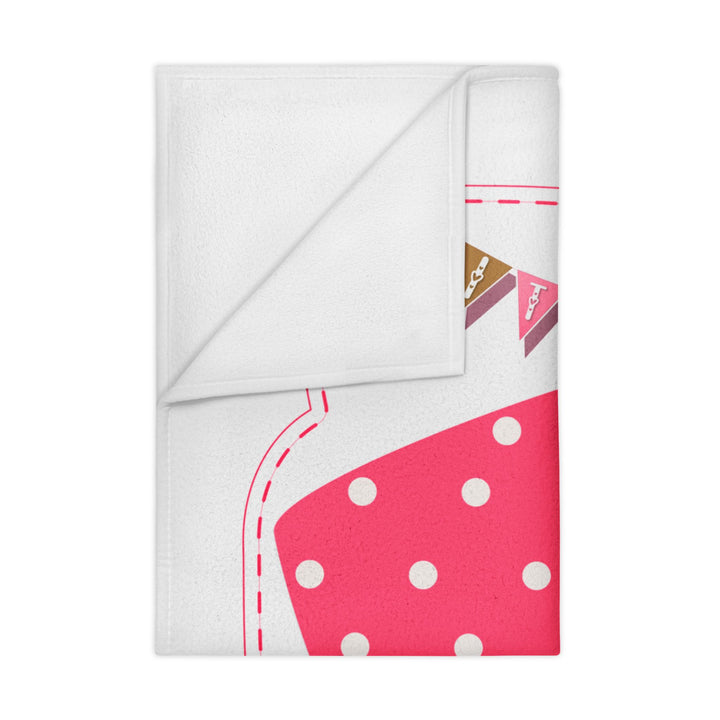 It's a Girl acrostic poem folded pink blanket with polka dot baby bodysuit design on white background