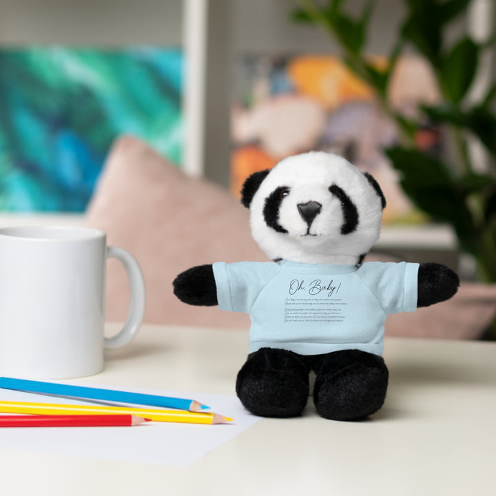 Stuffed panda toy wearing a blue shirt with acrostic poem spelling out Oh, Baby, placed on a surface with colored pencils and a mug.