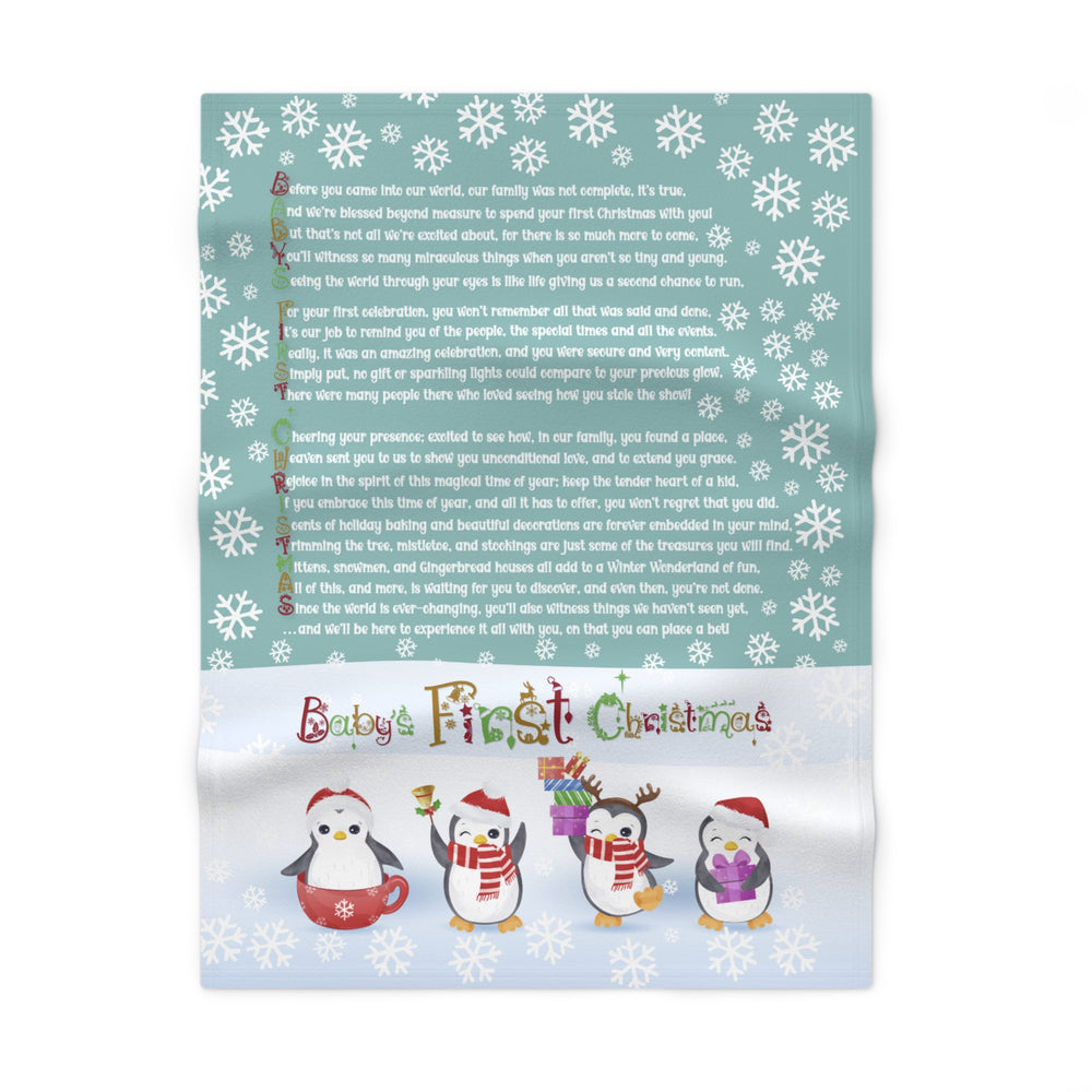 Baby's First Christmas blanket with penguin design and text on a white background
