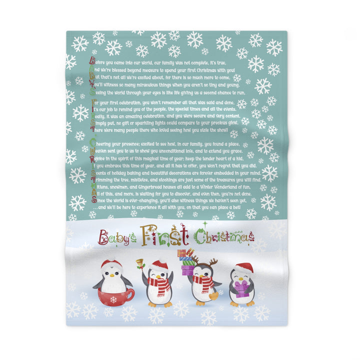 Baby's First Christmas blanket with penguin design and text on a white background