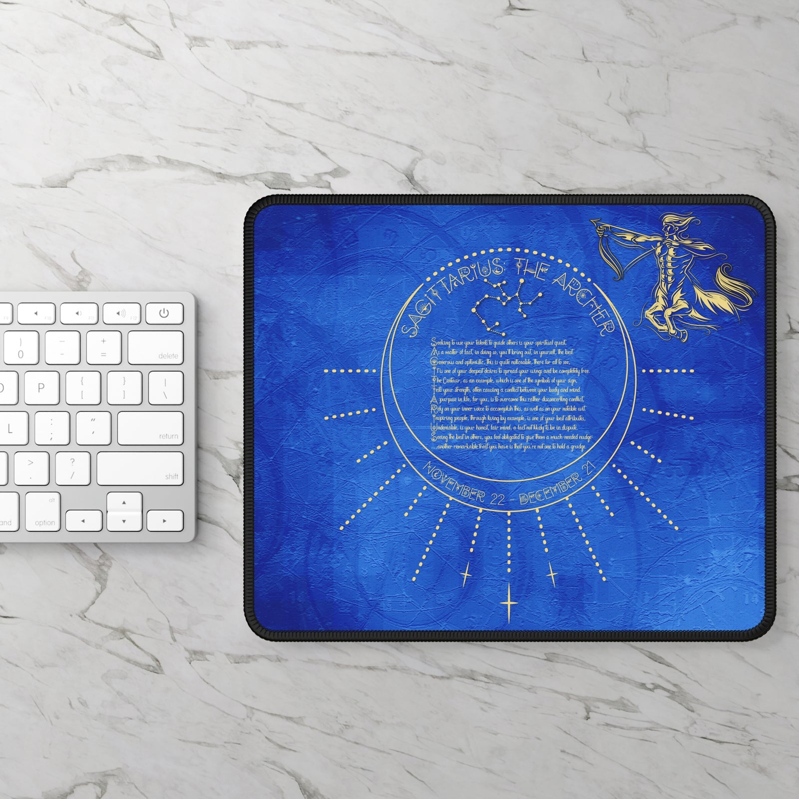 Blue acrostic poem spelling out Sagittarius mouse pad with gold design on a marble surface with keyboard