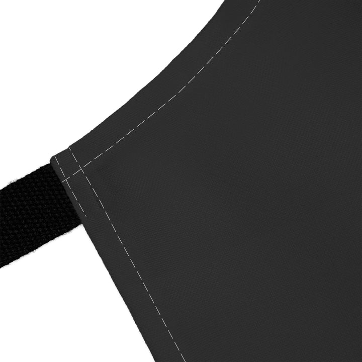 Close-up of a black apron with a white background