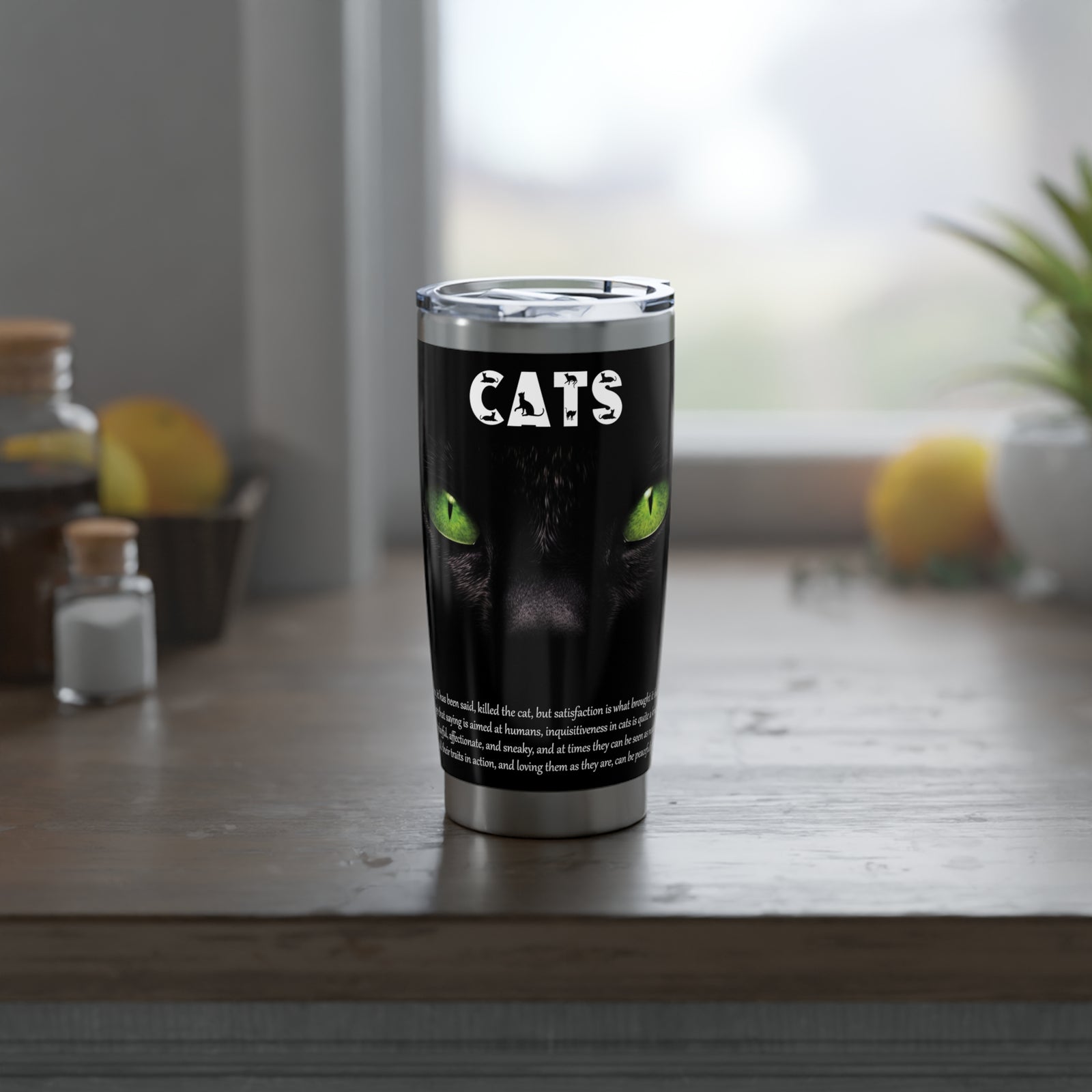 Tumbler with a cat design and acrostic poem that spells out 'CATS' text on a wooden surface.